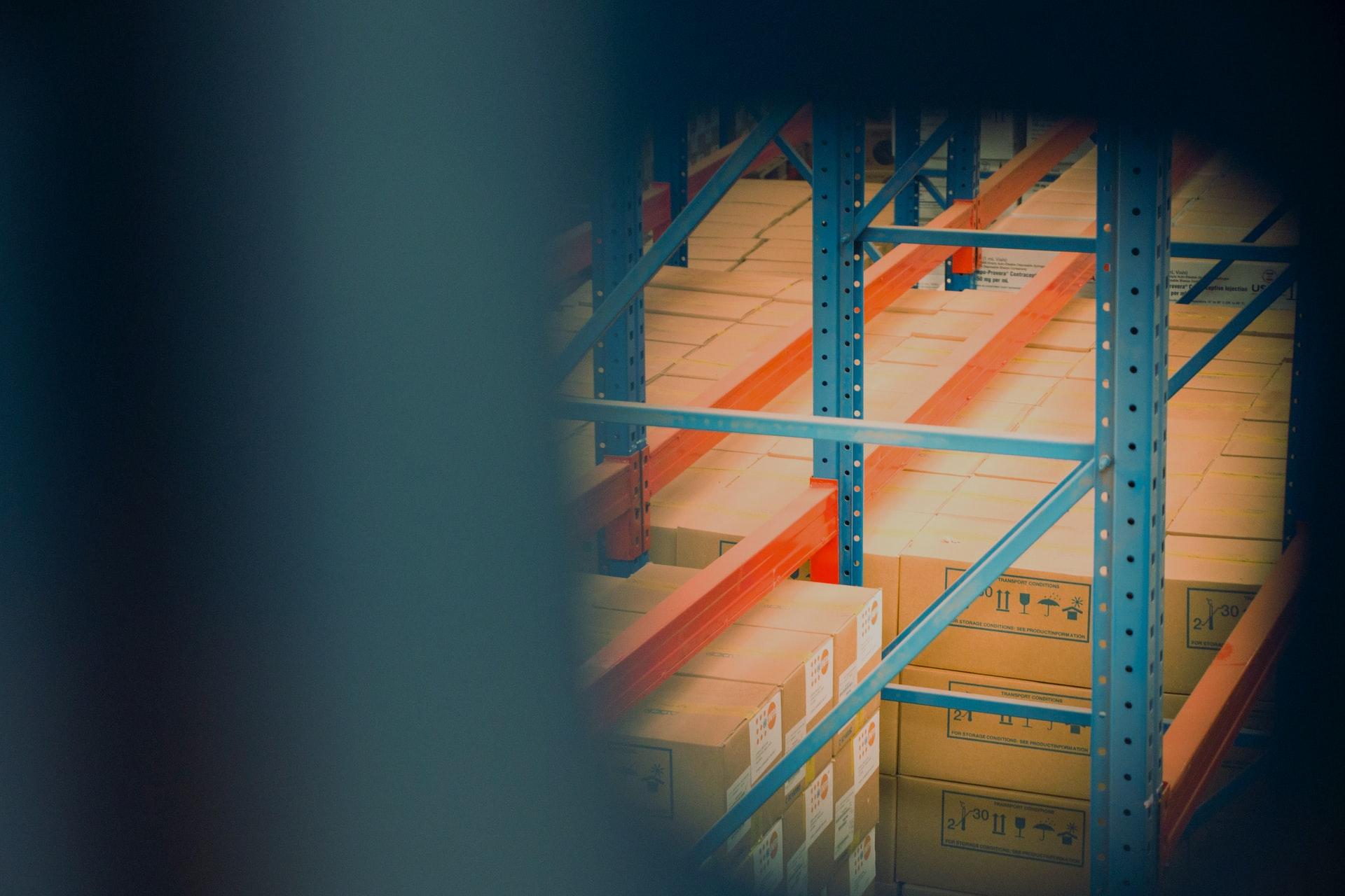 selective focus photography of brown boxes on gray shelf